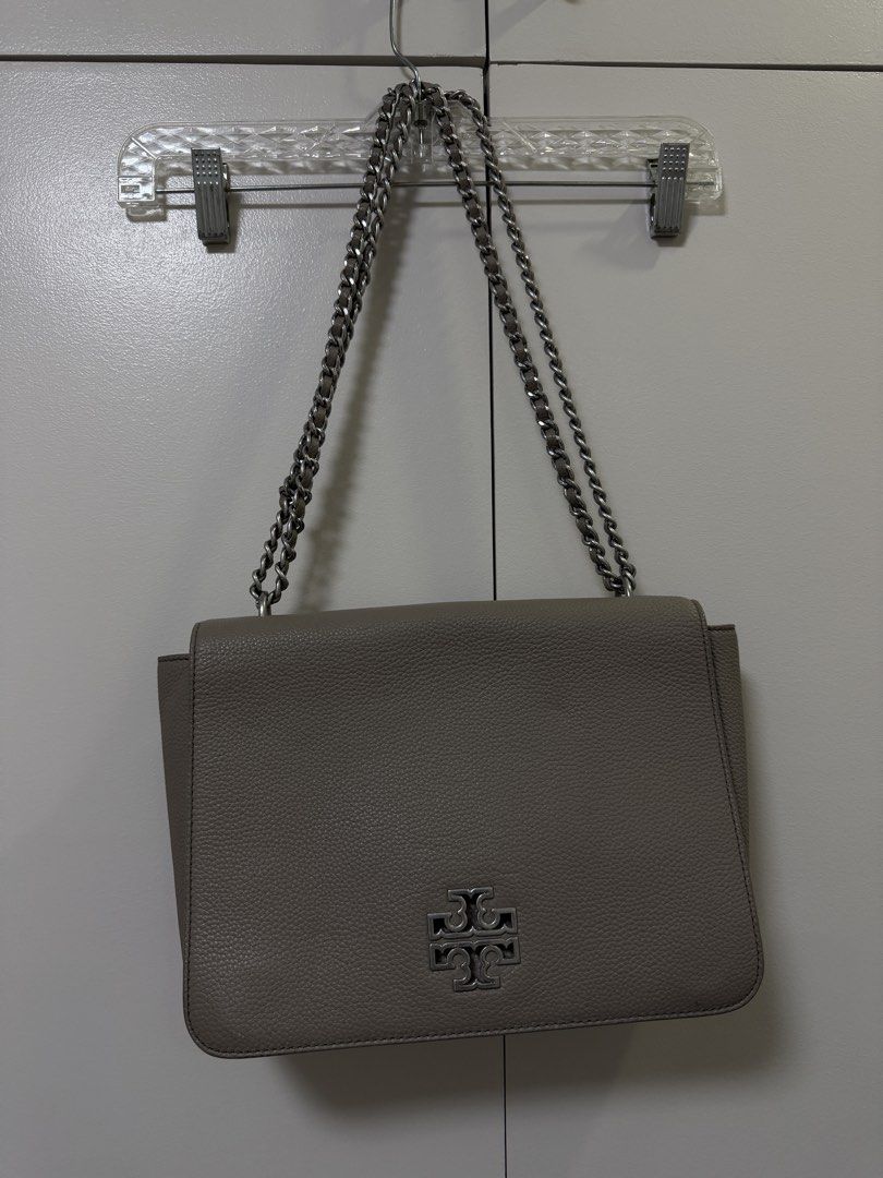 Tory Burch Britten Large Adjustable Shoulder Bag (Category: Luxury Bags & Wallets) located in Manila. Submitted by hola.koala (Listing ID 1427927454, Image 2). Description: Chain shoulder strap approx 12-20.5” strap length Flap closure Interior features 1 zip pocket, 1 slip pocket Leather Color gray Approx Measurements: 11” L x 8” H x 4” D Model 60401.