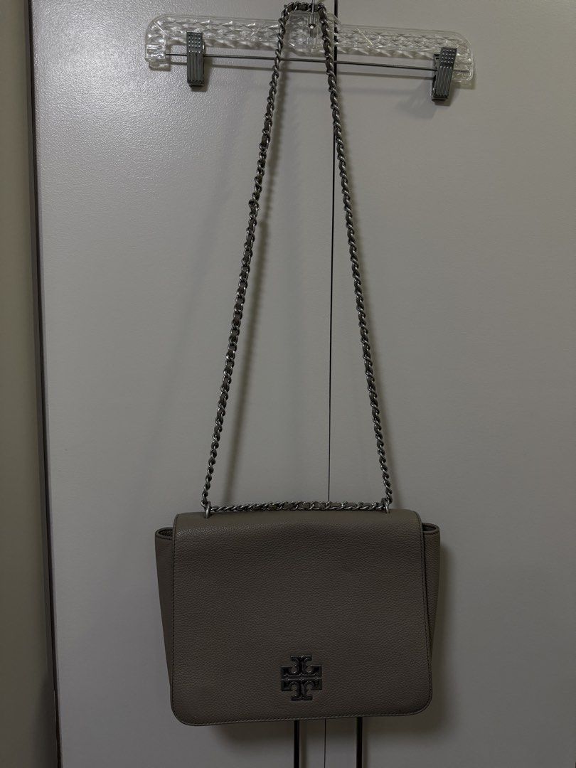 Tory Burch Britten Large Adjustable Shoulder Bag (Category: Luxury Bags & Wallets) located in Manila. Submitted by hola.koala (Listing ID 1427927454, Image 3). Description: Chain shoulder strap approx 12-20.5” strap length Flap closure Interior features 1 zip pocket, 1 slip pocket Leather Color gray Approx Measurements: 11” L x 8” H x 4” D Model 60401.