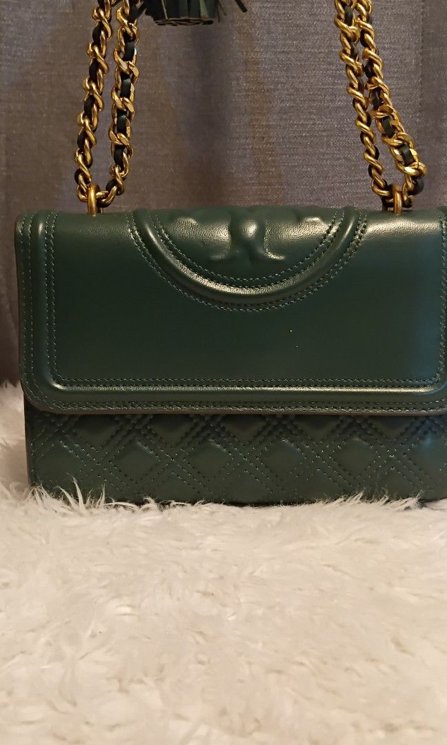 Tory Burch Green Quilted Shoulder Bag (Category: Luxury Bags & Wallets) located in San Juan City. Submitted by cheryl20624 (Listing ID 1427897152, Image 2). Description: Tory Burch shoulder bag features a quilted design and a gold chain strap. The bag has a flap closure with the Tory Burch logo. The exterior is a vibrant green color. It has a rectangular shape with a diamond pattern on the lower part of the bag. The strap is a combination of leat
