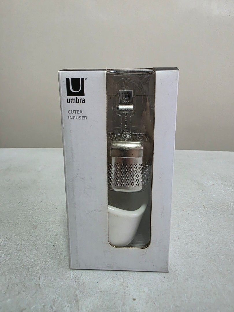 Umbra cutea infuser (Category: Coffee & Tea Tableware) located in Manila. Submitted by tch_86 (Listing ID 1427789420, Image 1). Description: For coffee or tea lovers out there or your gift idea! Dimension : 2.5"L x 2"W x 2.5"H Materual: Ceramic Pull the chain out, steep your tea and tuck the chain away when you're done Metal tea infuser with matte ceramic saucer Designed by Eugenie De Loynes.