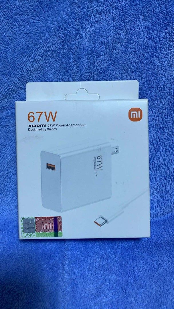 Xiaomi 67W Power Adapter (Category: Chargers & Cables) located in Manila. Submitted by pricious (Listing ID 1427887151, Image 1). Description: Xiaomi 67W Power Adapter. Designed by Xiaomi. Includes the adapter and a USB-C cable. The box is white with the Xiaomi logo. The adapter is white and has a USB-C port. The box indicates it is a 67W charger..