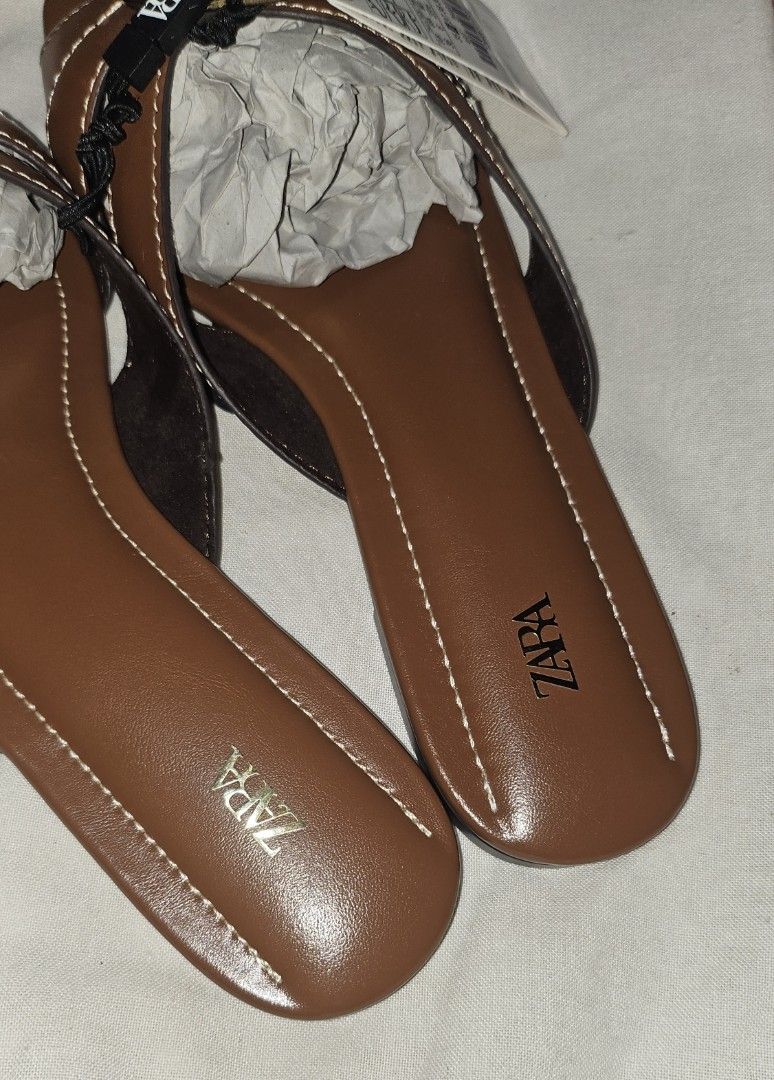 Zara Brown Leather Sandals Size 36 (Category: Flats & Sandals) located in Pamplona. Submitted by luxuryitems_ph (Listing ID 1427887468, Image 2). Description: Genuine Zara sandals in brown leather. Features a buckle detail and a comfortable design. Size 36, as indicated on the sole. Includes original tags & dust bag. The sandals are new and unworn. Original Price 🔖2.5k plus.