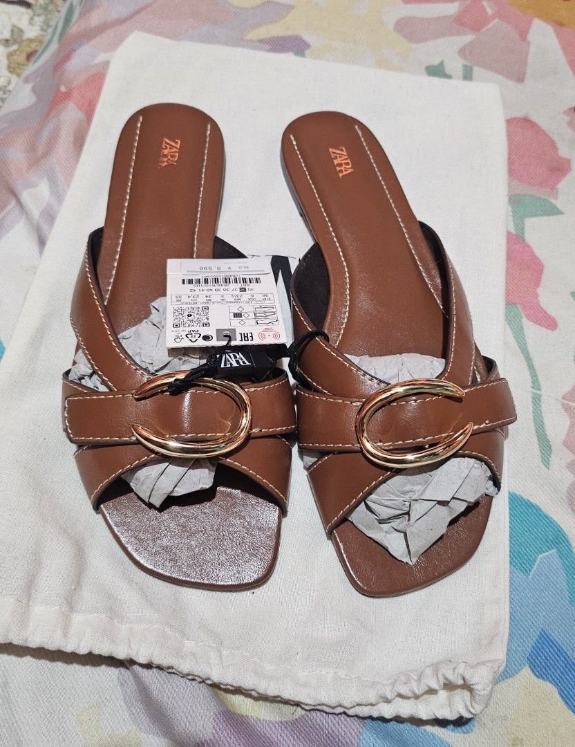 Zara Brown Leather Sandals Size 36 (Category: Flats & Sandals) located in Pamplona. Submitted by luxuryitems_ph (Listing ID 1427887468, Image 1). Description: Genuine Zara sandals in brown leather. Features a buckle detail and a comfortable design. Size 36, as indicated on the sole. Includes original tags & dust bag. The sandals are new and unworn. Original Price 🔖2.5k plus.