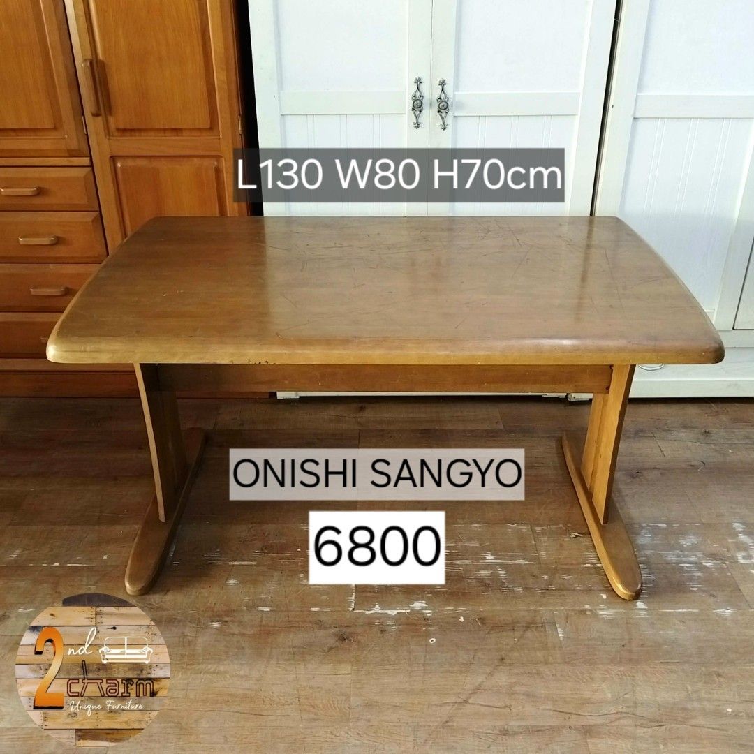 2nd hand ONISHI SANGYO Dining Table | Solid Wood (Category: Tables & Sets) located in Paranaque City. Submitted by feybelhaft (Listing ID 1428036133, Image 2). Description: Solid wooden table by Onishi Sangyo. Features a rectangular tabletop with rounded edges and sturdy, curved legs. Dimensions are L130cm x W80cm x H70cm. The table has a natural wood finish. Perfect for dining or as a workspace. A classic piece that adds warmth to any room..