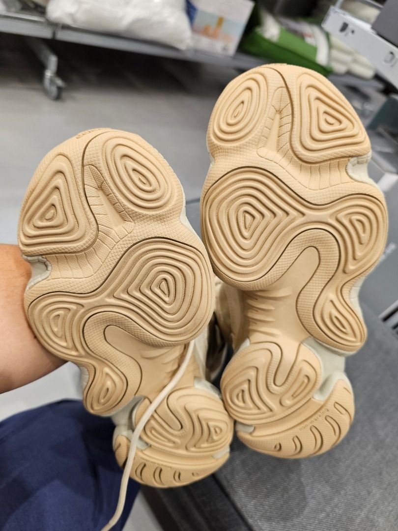 Adidas Yeezy 500 Tactical Boots (Category: Boots) located in Taguig. Submitted by suque_shop (Listing ID 1428084373, Image 3). Description: These Adidas Yeezy NSLTD Boots feature a tan colorway. They have a unique design with a padded upper and a chunky sole. The boots have a lace-up closure and a high-top design. The soles show a distinctive pattern for grip. They appear to be well-maintained and ready for wear..