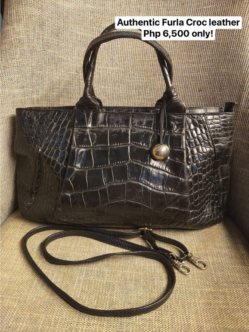 Authentic Furla Croc Leather Handbag (Category: Luxury Bags & Wallets) located in Quezon City. Submitted by graciasluxurybag (Listing ID 1427972541, Image 1). Description: Authentic Furla handbag crafted from croc-embossed leather. Features a top handle and a detachable shoulder strap for versatile carrying options. The bag has a sleek, structured design with a silver-tone metal detail. The color is black. Includes a price of PHP 6,500..