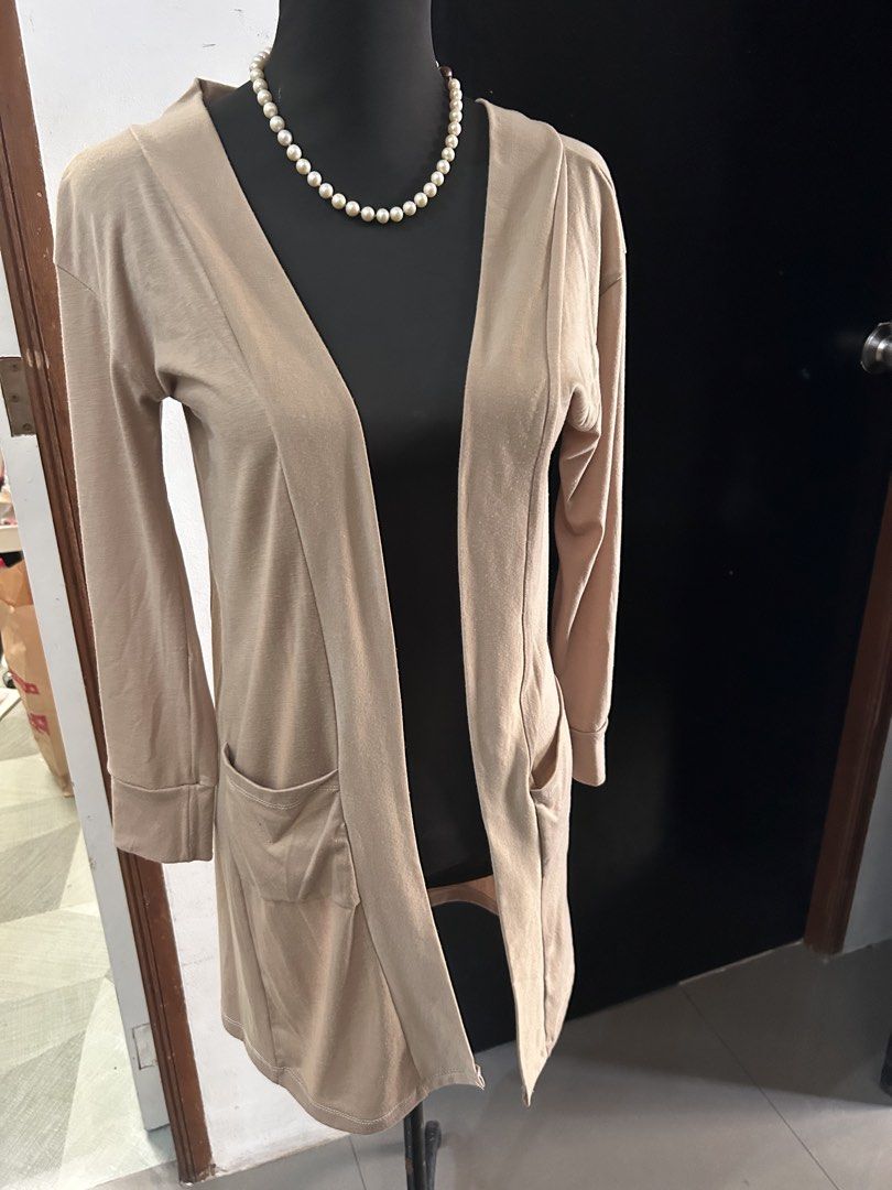 Beige / Khaki / Brown Cardigan with Pockets (Category: Coats, Jackets and Outerwear) located in Quezon City. Submitted by lovediary (Listing ID 1428041885, Image 1). Description: - no issues - first M-L frame • shipping from bulacan • no rush shipping • shipping via jnt / flash • mop: mari bank / gcash Beige cardigan features a longline design with two front pockets. It has long sleeves and a classic open front. The cardigan is a versatile piece,