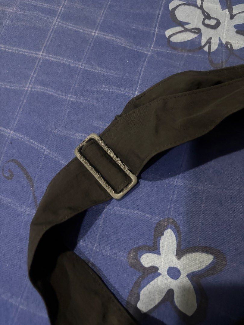 Beyond The Vines Dumpling Bag (Category: Cross-body Bags) located in Quezon City. Submitted by b_declutter (Listing ID 1428041509, Image 3). Description: Black Beyond The Vines Dumpling Bag. Features a main compartment with a drawstring closure. Includes a small front pocket with the brand name. Comes with a detachable shoulder strap. The bag has a unique, rounded shape. The strap has a metal buckle..