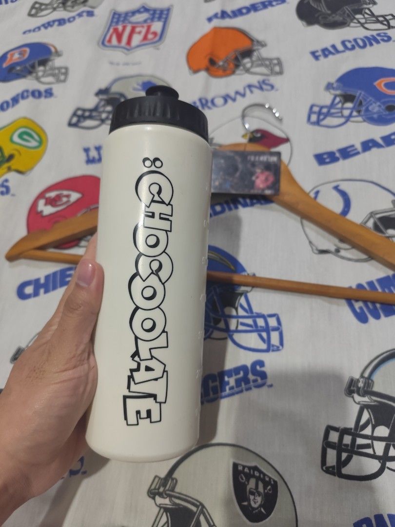 Chocolate Garfield Water Bottle (Category: Water Bottles & Tumblers) located in Baguio. Submitted by FRANKLIN (Listing ID 1428062717, Image 1). Description: Water bottle features a design with the word "Chocolate" on one side and a Garfield graphic on the other. It has a black cap and white body with measurement markings up to 700ml. It is a great item for carrying water or other beverages..