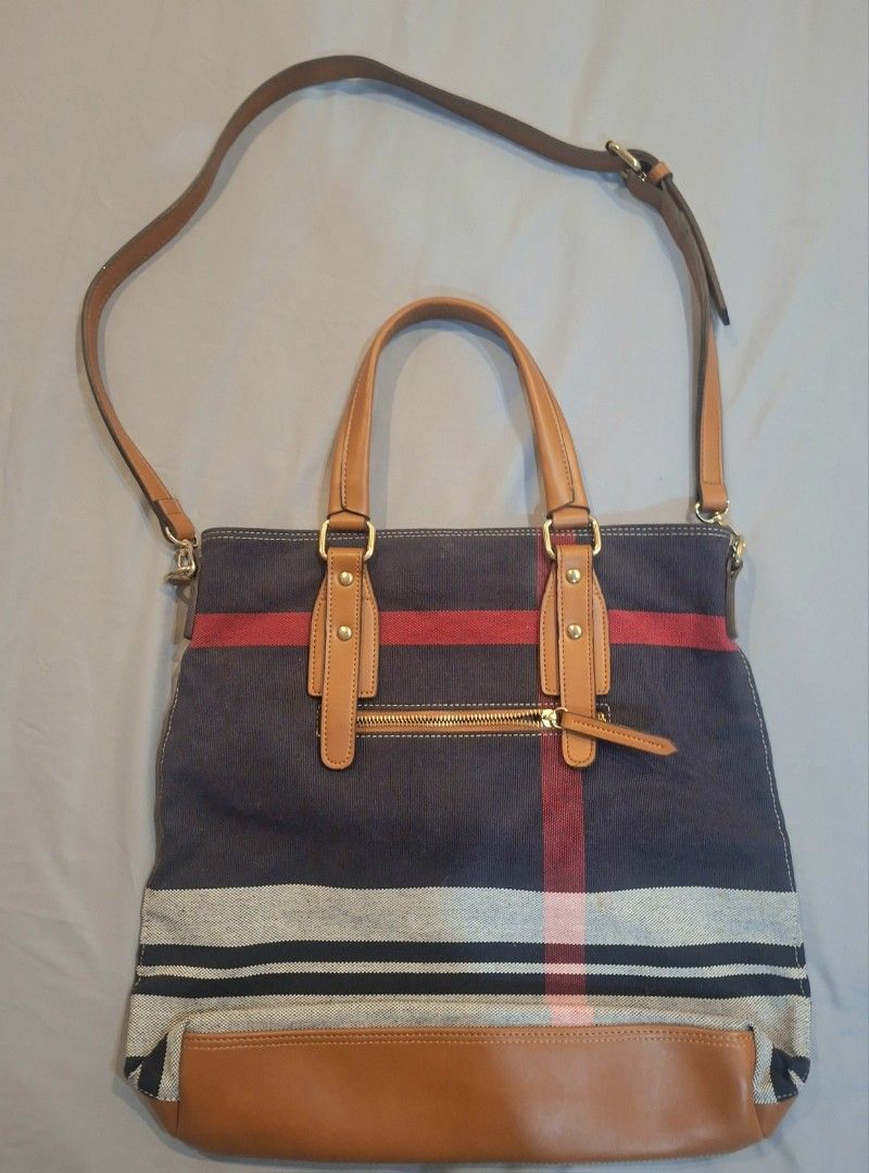 Christian Rozen Tote Bag with Shoulder Strap (Category: Tote Bags) located in Las Pinas. Submitted by bethany1965 (Listing ID 1427991539, Image 2). Description: Never been used, gifted to me last Christmas. Stylish tote bag by Christian Rozen. Features a navy blue fabric with red and white stripes. It has brown leather handles and a detachable shoulder strap. The bag includes a front pocket and a zippered main compartment. The Christian Rozen log