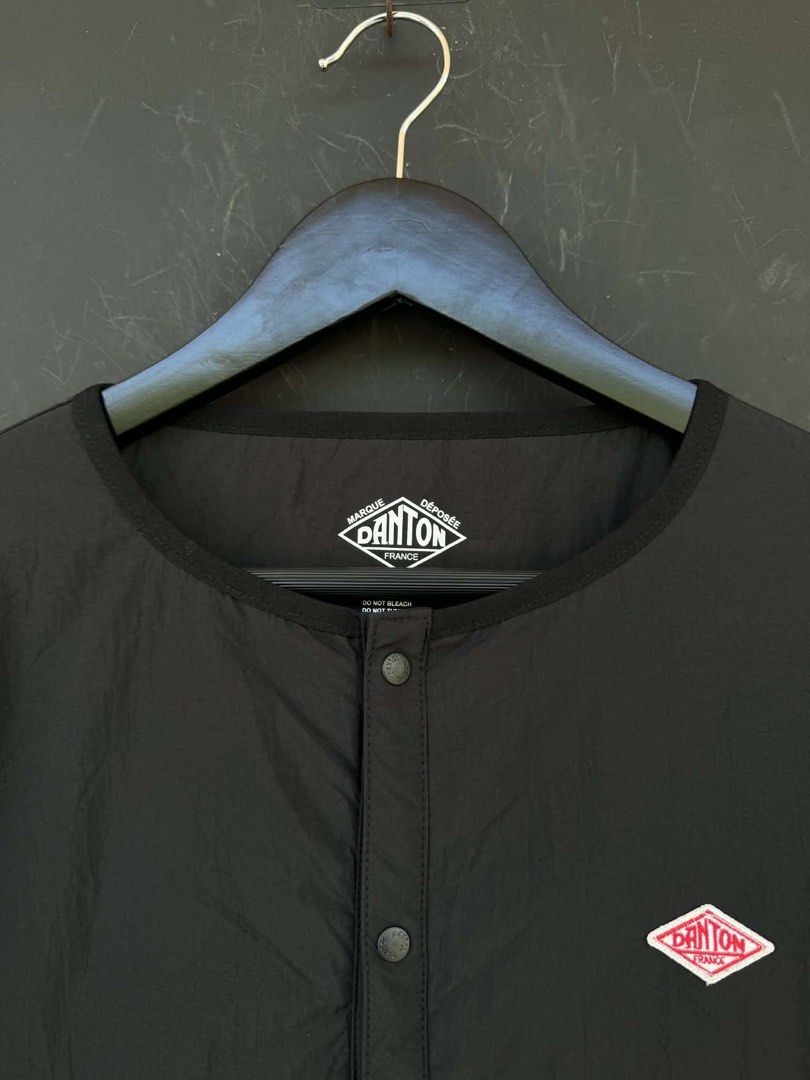 Danton Black Jacket (Category: Coats, Jackets and Outerwear) located in Manila. Submitted by archivedrip (Listing ID 1428065677, Image 2). Description: Black Danton jacket. Features a round collar, button closure, and two front pockets with zippers. The jacket has the Danton logo on the chest and inside the collar. The tag indicates the jacket is made of nylon and polyester. It also provides washing instructions..