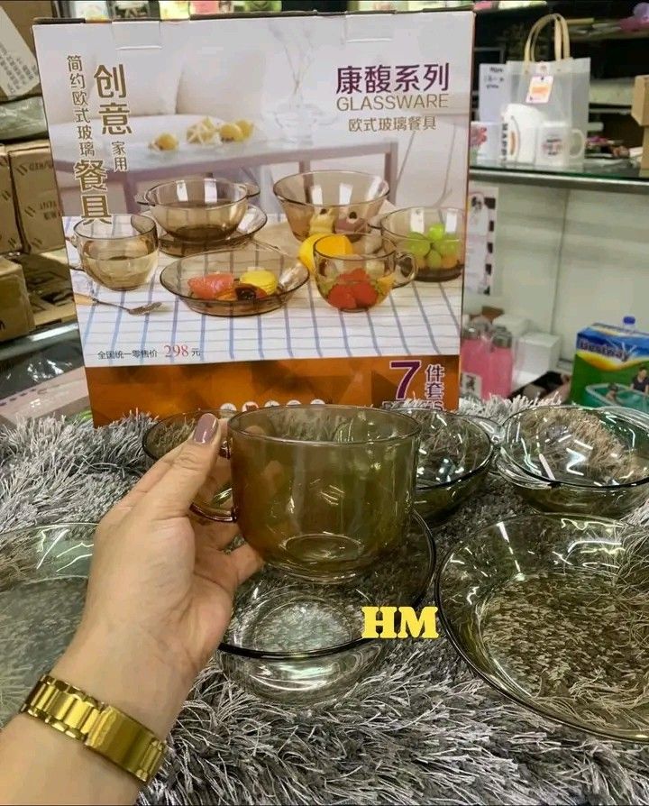 Glassware Set 7-Piece (Category: Other Kitchenware & Tableware) located in Manila. Submitted by legitseller_angel06 (Listing ID 1427936815, Image 2). Description: Glassware set includes 7 pieces. The set features a brown tint and includes bowls, cups, and plates. The packaging shows the set is designed for home use..