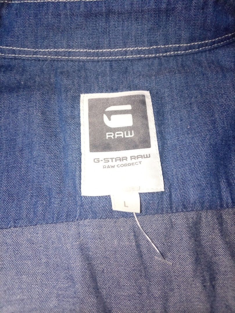G-Star Raw Denim Shirt - Size L (Category: Tshirts & Polo Shirts ) located in Las Pinas. Submitted by dydythrift74 (Listing ID 1428043514, Image 2). Description: Authentic G-Star Raw denim shirt in size L. Features a classic button-down design with a mandarin collar. The shirt has long sleeves with buttoned cuffs and the G-Star Raw logo on the chest..