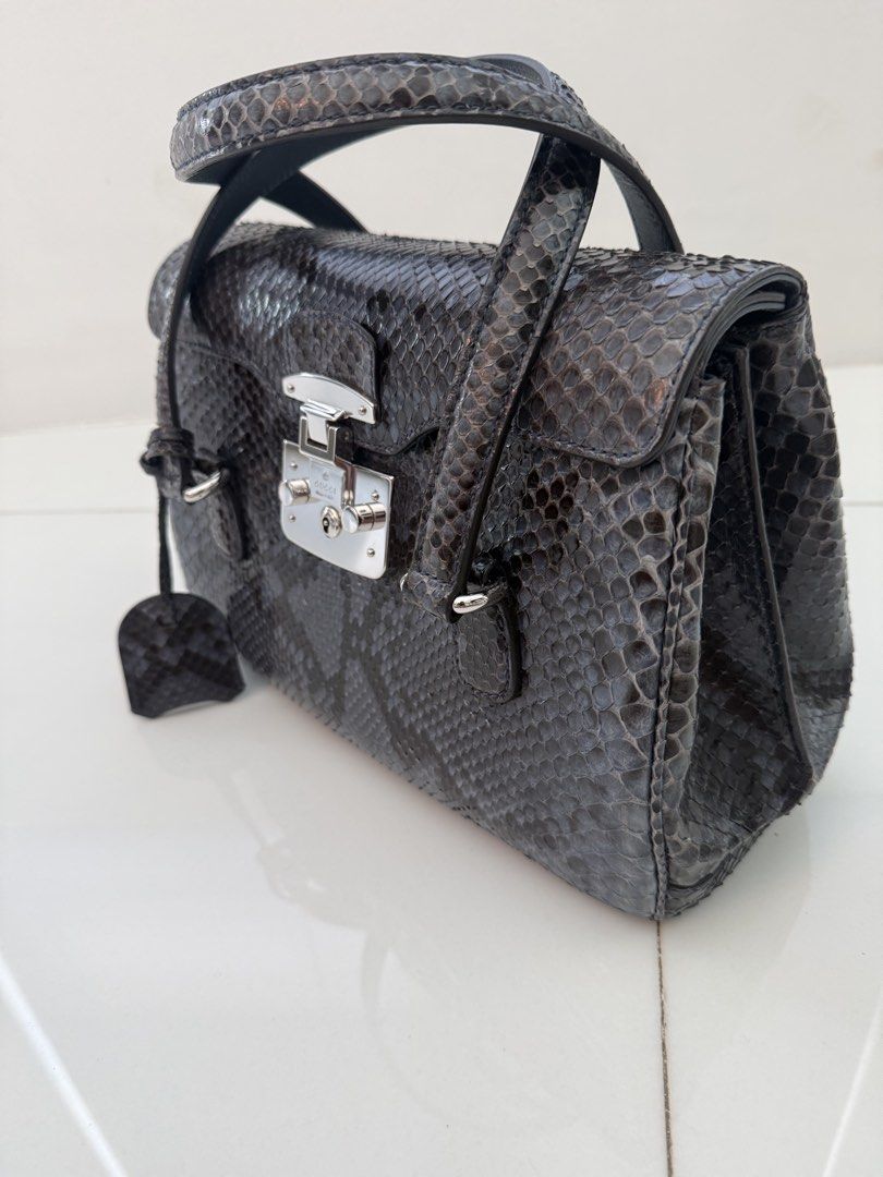 Gucci Python Leather Handbag (Category: Bags & Wallets) located in Singapore. Submitted by billettan (Listing ID 1428009700, Image 3). Description: - Beautiful python leather handbag - Top handle design - Secure clasp closure - Multiple interior compartments - Minimal signs of wear - Stylish and unique accessory - Dust bag n box in new condition. .