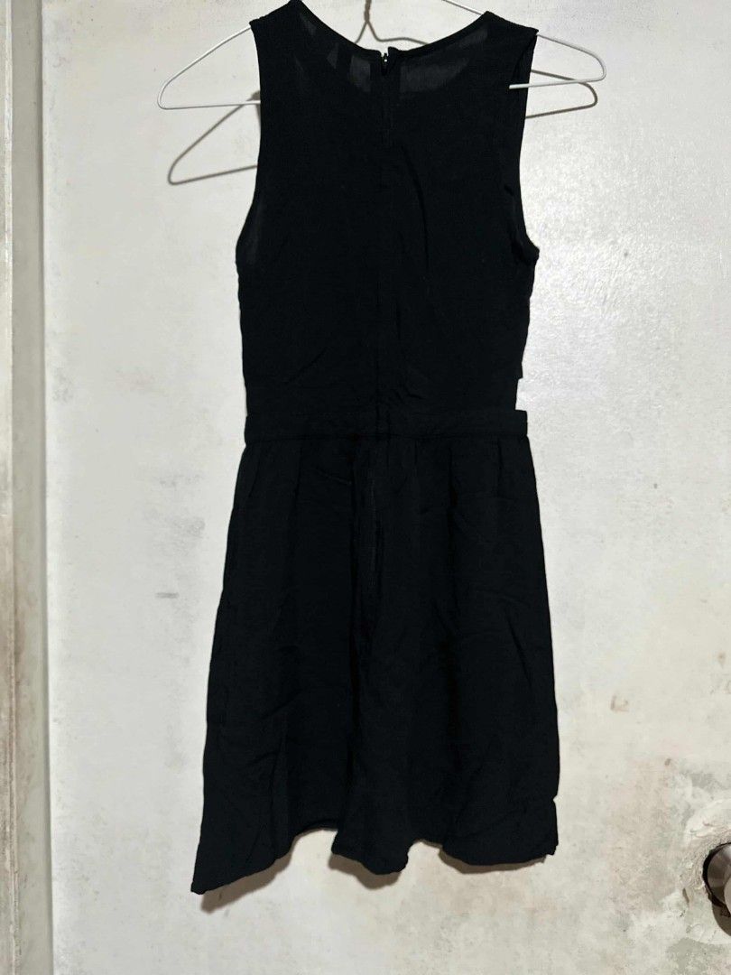 H&M Divided Black Cutout Dress (Category: Dresses) located in Pasig City. Submitted by rkclosets (Listing ID 1428013346, Image 1). Description: Black dress from H&M Divided. Features a cutout design at the waist and shoulders. Sleeveless with a zipper closure at the back. The tag indicates size EUR 32, US 2, CN 155/76A, and MX 2. Made of a lightweight fabric..