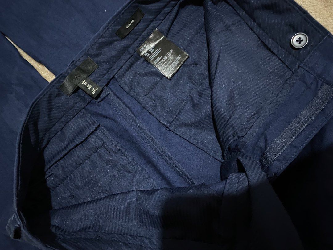 H&M Slim Fit Navy Blue Slacks (Category: Trousers) located in Caloocan City. Submitted by declutterieee (Listing ID 1428093209, Image 2). Description: Navy blue slim fit pants from H&M. Features a button and zipper closure. The tag indicates size EUR 44, US 30R, and MX 30R. Made in Bangladesh. Shell: 50% cotton, 50% polyester. Pocket: 80% polyester, 20% cotton. - Never nasuot sinukat lng, Nastock lng sa cabinet - No issue - Waist 29-30 - L 40.