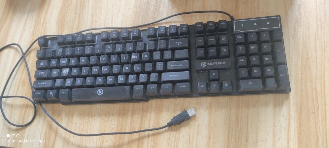 Keytech Keyboard (Category: Computer Keyboard) located in Cavite. Submitted by Combiishop (Listing ID 1427952102, Image 2). Description: Black Keytech keyboard with USB connector. Features a full-sized layout including a number pad. The keyboard has visible wear on the keys. The keyboard is suitable for general use..