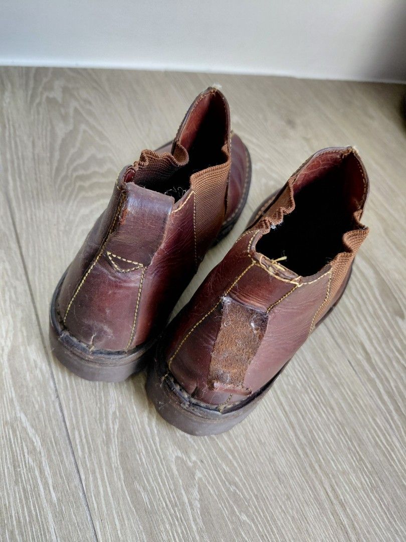 Cole Haan Leather Slip-on Boots (Category: Boots) located in Quezon City. Submitted by mkaeo (Listing ID 1427939791, Image 3). Description: Brown leather slip-on shoes. Features a rugged sole and elastic side panels for easy wear. The shoes have visible stitching details and a textured sole for grip. The brand name is visible on the sole. These shoes are suitable for casual wear. as is. original tumigas na yung leather. maybe you know how to clea