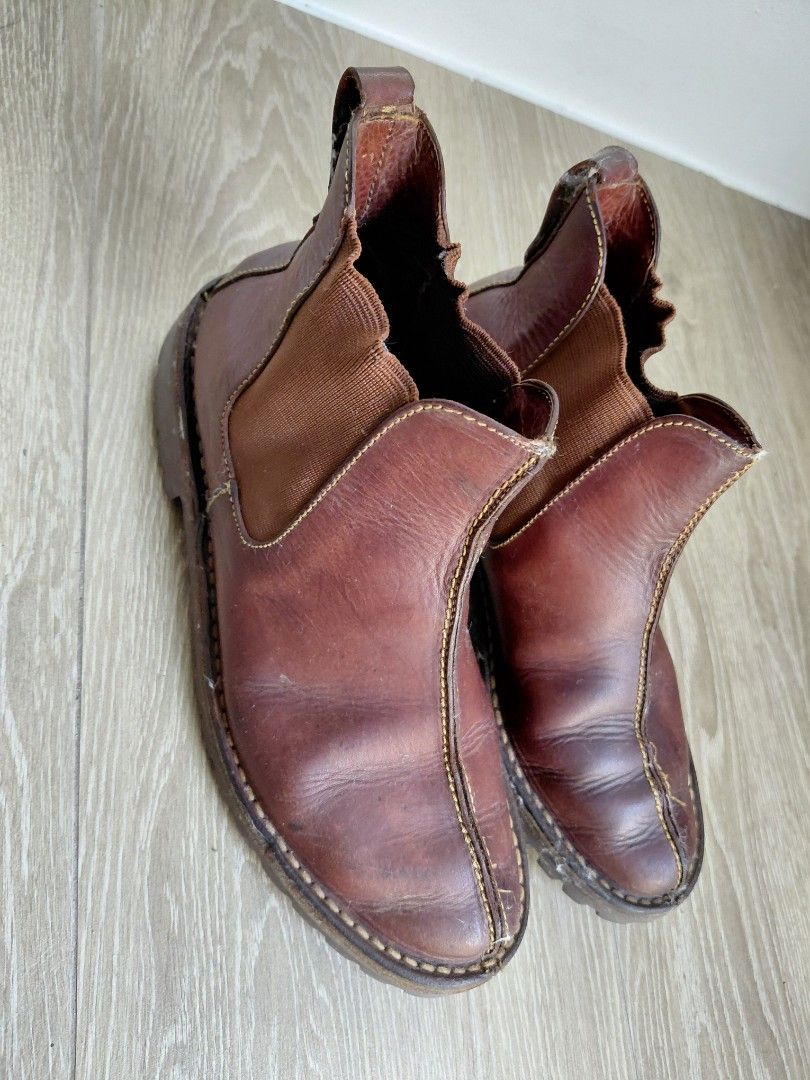 Cole Haan Leather Slip-on Boots (Category: Boots) located in Quezon City. Submitted by mkaeo (Listing ID 1427939791, Image 2). Description: Brown leather slip-on shoes. Features a rugged sole and elastic side panels for easy wear. The shoes have visible stitching details and a textured sole for grip. The brand name is visible on the sole. These shoes are suitable for casual wear. as is. original tumigas na yung leather. maybe you know how to clea