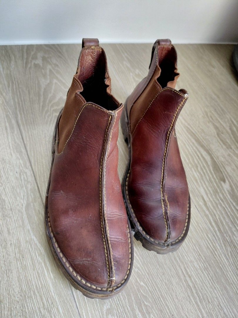 Cole Haan Leather Slip-on Boots (Category: Boots) located in Quezon City. Submitted by mkaeo (Listing ID 1427939791, Image 1). Description: Brown leather slip-on shoes. Features a rugged sole and elastic side panels for easy wear. The shoes have visible stitching details and a textured sole for grip. The brand name is visible on the sole. These shoes are suitable for casual wear. as is. original tumigas na yung leather. maybe you know how to clea