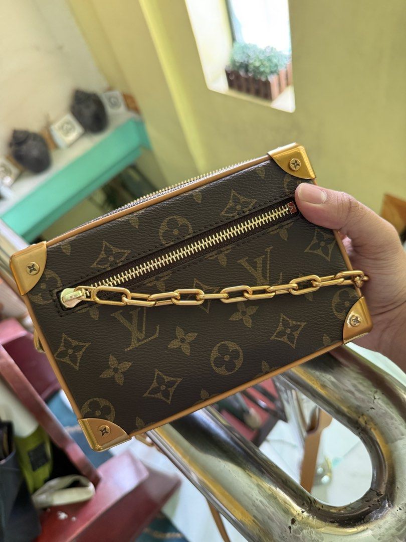 Louis Vuitton Soft Trunk Monogram Crossbody bag (Category: Luxury Bags & Wallets) located in Cabuyao City. Submitted by gerlieluxurycloset2024 (Listing ID 1428010027, Image 1). Description: Louis Vuitton Petite Malle handbag. Features the iconic Monogram canvas, gold-tone hardware, and a chain strap. The interior includes a small pocket and a leather tag. Comes with a dust bag. The bag has a structured shape with a zip closure. Complete with dust