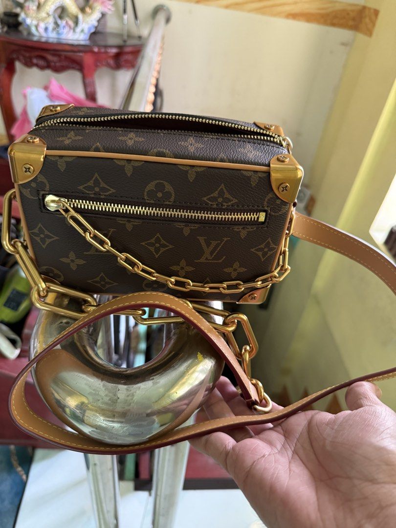 Louis Vuitton Soft Trunk Monogram Crossbody bag (Category: Luxury Bags & Wallets) located in Cabuyao City. Submitted by gerlieluxurycloset2024 (Listing ID 1428010027, Image 2). Description: Louis Vuitton Petite Malle handbag. Features the iconic Monogram canvas, gold-tone hardware, and a chain strap. The interior includes a small pocket and a leather tag. Comes with a dust bag. The bag has a structured shape with a zip closure. Complete with dust