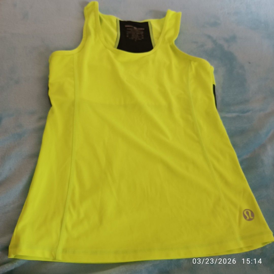 Lululemon Athletica Tank Top - Size 10 (Category: Activewear) located in Bacoor. Submitted by pamelott (Listing ID 1427994109, Image 2). Description: Color: Neon yellow Style: Sleeveless tank top Fit: Relaxed / slightly flowy Fabric: Lightweight, breathable, moisture-wicking Features: Scoop neckline, minimal seams, logo detail Perfect for workouts, yoga, running, or casual athleisure wear..