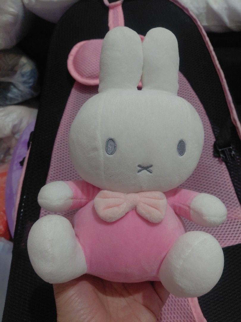 Miffy in Pink Plush Toy (Category: Plushies & Soft Toys) located in Manila. Submitted by bashamylove0116 (Listing ID 1427998185, Image 1). Description: Adorable Miffy Pink plush toy. Features a white bunny head with blue eyes and a pink body with a bow. The toy is soft and cuddly, perfect for kids or collectors. The tag indicates it's an official Miffy product. A cute and charming addition to any collection..
