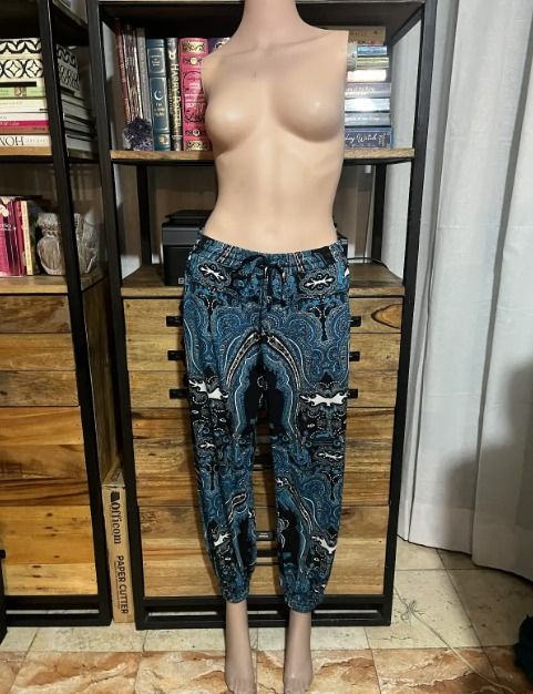 PAISLEY CUSTOM Blue Print Jogger Pants (Category: Other Bottoms) located in Mandaluyong City. Submitted by pattyph (Listing ID 1427624136, Image 1). Description: These jogger pants feature a vibrant paisley print in shades of blue and black. They have an elastic waistband with a drawstring for an adjustable fit. The pants have a relaxed fit with cuffed ankles. Perfect for casual wear, these pants offer both style and comfort. They also include po