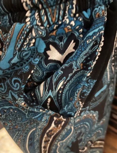 PAISLEY CUSTOM Blue Print Jogger Pants (Category: Other Bottoms) located in Mandaluyong City. Submitted by pattyph (Listing ID 1427624136, Image 2). Description: These jogger pants feature a vibrant paisley print in shades of blue and black. They have an elastic waistband with a drawstring for an adjustable fit. The pants have a relaxed fit with cuffed ankles. Perfect for casual wear, these pants offer both style and comfort. They also include po