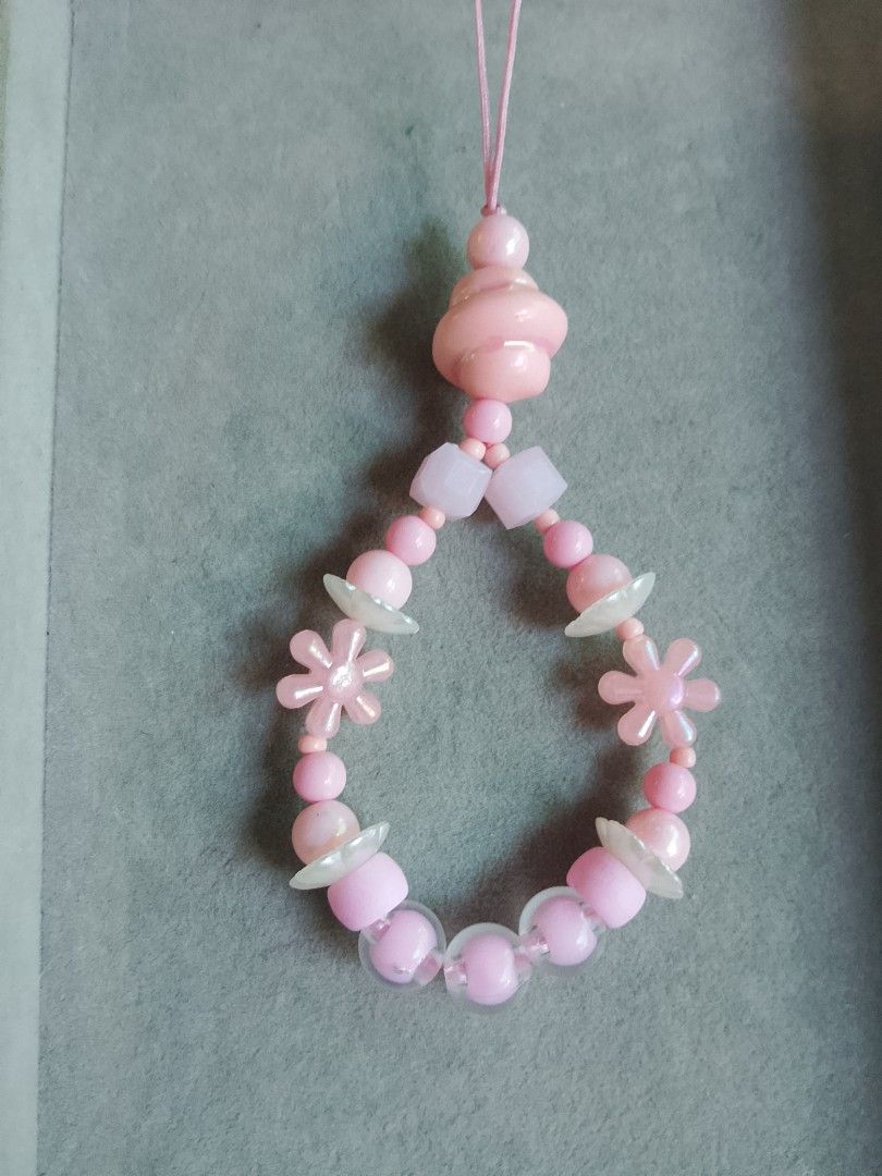 Pink Beaded Phone Charm (Category: Charms) located in Manila. Submitted by swiftdragon-85a76b (Listing ID 1427996752, Image 1). Description: Charming phone accessory features a delicate design with pink beads and floral accents. It includes a loop for easy attachment to your phone. The charm is made of various shapes and sizes of pink beads, with flower-shaped and other decorative elements. It's a cute and stylish way to personalize your phone..