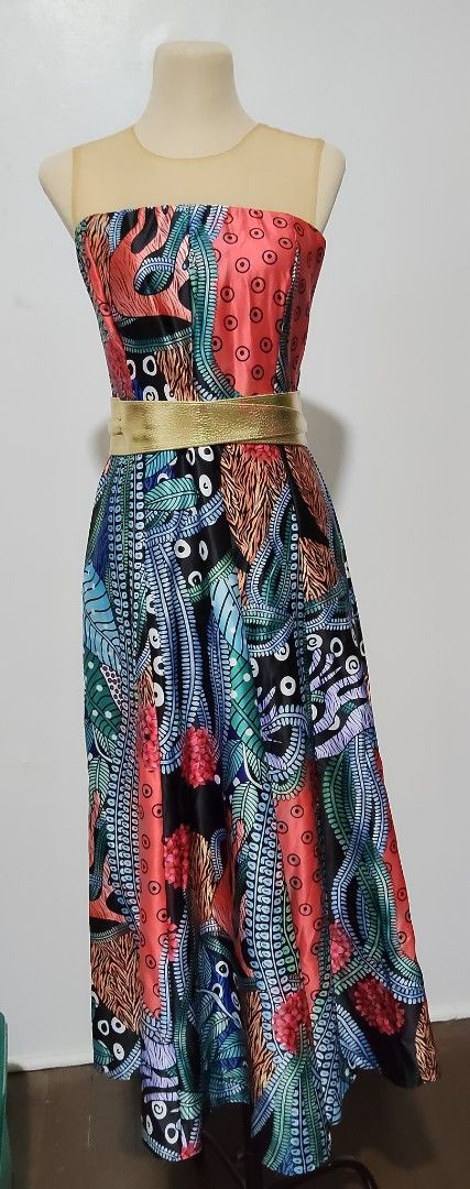 Printed Midi Dress with Belt (Category: Dresses) located in Manila. Submitted by audrey03 (Listing ID 1428078852, Image 2). Description: Elegant midi dress featuring a vibrant floral and abstract print. It has a strapless design with a sheer neckline and a fitted bodice. The dress includes a gold-colored belt to cinch the waist. The skirt flows down to a midi length, creating a flattering silhouette. Perfect for special occasions. SF c/o buyer.