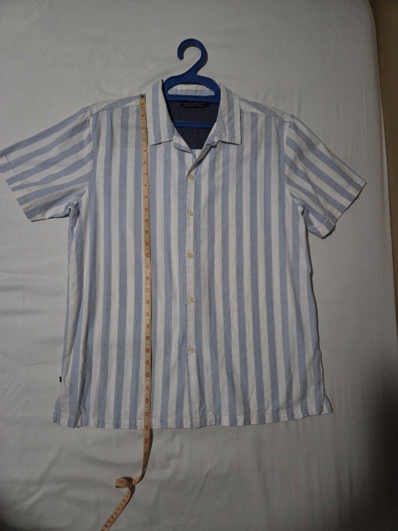Regatta Striped Short Sleeve Shirt (Category: Tshirts & Polo Shirts ) located in Pasig City. Submitted by ldcayas (Listing ID 1428042414, Image 3). Description: Regatta short sleeve shirt features a light blue and white striped pattern. It has a button-down front and a collared neckline. The shirt is made of 100% cotton. The shirt has a small logo on the chest. Measurements Chest - Approx 21 inches Shoulder to Hem - Approx 28 inches Mode of Payme