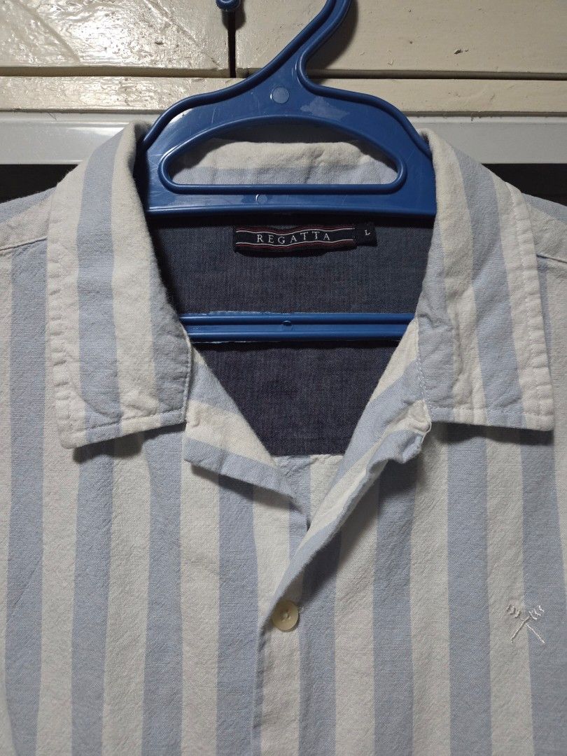 Regatta Striped Short Sleeve Shirt (Category: Tshirts & Polo Shirts ) located in Pasig City. Submitted by ldcayas (Listing ID 1428042414, Image 2). Description: Regatta short sleeve shirt features a light blue and white striped pattern. It has a button-down front and a collared neckline. The shirt is made of 100% cotton. The shirt has a small logo on the chest. Measurements Chest - Approx 21 inches Shoulder to Hem - Approx 28 inches Mode of Payme
