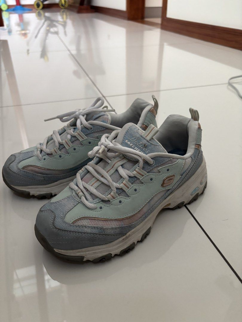 Skechers D'Lites Sneakers - US 7 (Category: Sneakers) located in Quezon City. Submitted by bingbnb (Listing ID 1428094783, Image 1). Description: Skechers D'Lites sneakers in a blue and gray colorway. Features Air-Cooled Memory Foam insoles. Size US 7, UK 4, EUR 37, 240 (LBM). The shoes have laces and a padded collar. The shoes have a light blue and gray color scheme..