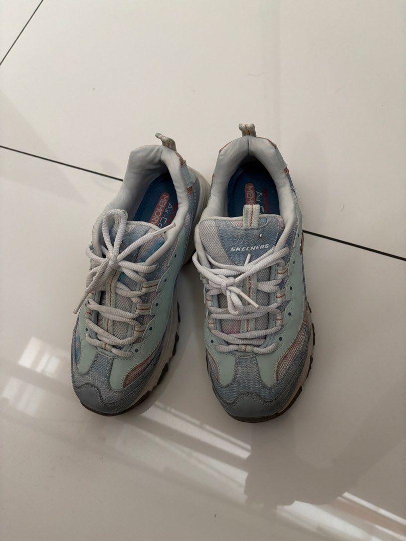 Skechers D'Lites Sneakers - US 7 (Category: Sneakers) located in Quezon City. Submitted by bingbnb (Listing ID 1428094783, Image 2). Description: Skechers D'Lites sneakers in a blue and gray colorway. Features Air-Cooled Memory Foam insoles. Size US 7, UK 4, EUR 37, 240 (LBM). The shoes have laces and a padded collar. The shoes have a light blue and gray color scheme..