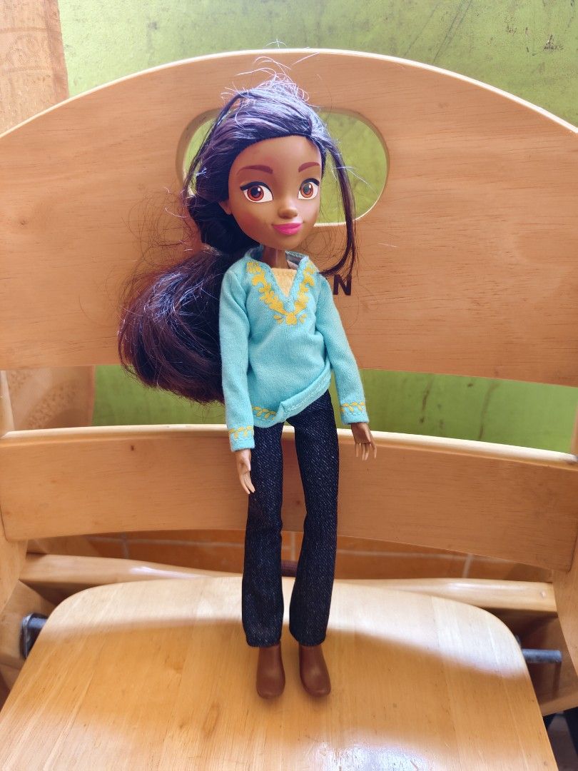 Spirit Untamed Doll (Category: Figurines & Statues) located in Manila. Submitted by 3ds_jpn (Listing ID 1428038091, Image 1). Description: Doll features long dark hair and is wearing a light blue top with yellow detailing, dark pants, and brown boots. The doll is standing on a wooden chair..