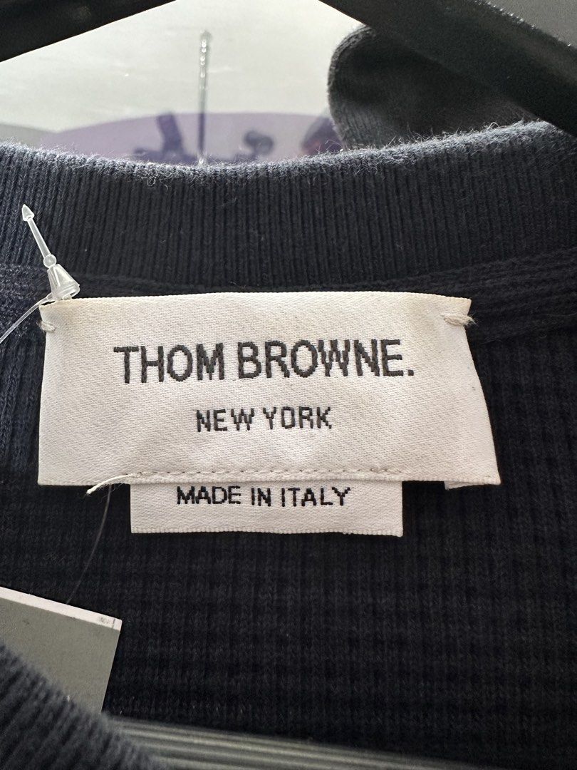 Thom Browne Black Sweatshirt with Stripes (Category: Luxury Apparel) located in Manila. Submitted by archivedrip (Listing ID 1428096550, Image 2). Description: Authentic Thom Browne sweatshirt in black. Features the brand's signature white stripes on the left sleeve. Made in Italy. The fabric composition includes cotton and elastane. Details include buttoned cuffs and a crew neck. The size is indicated as 1..