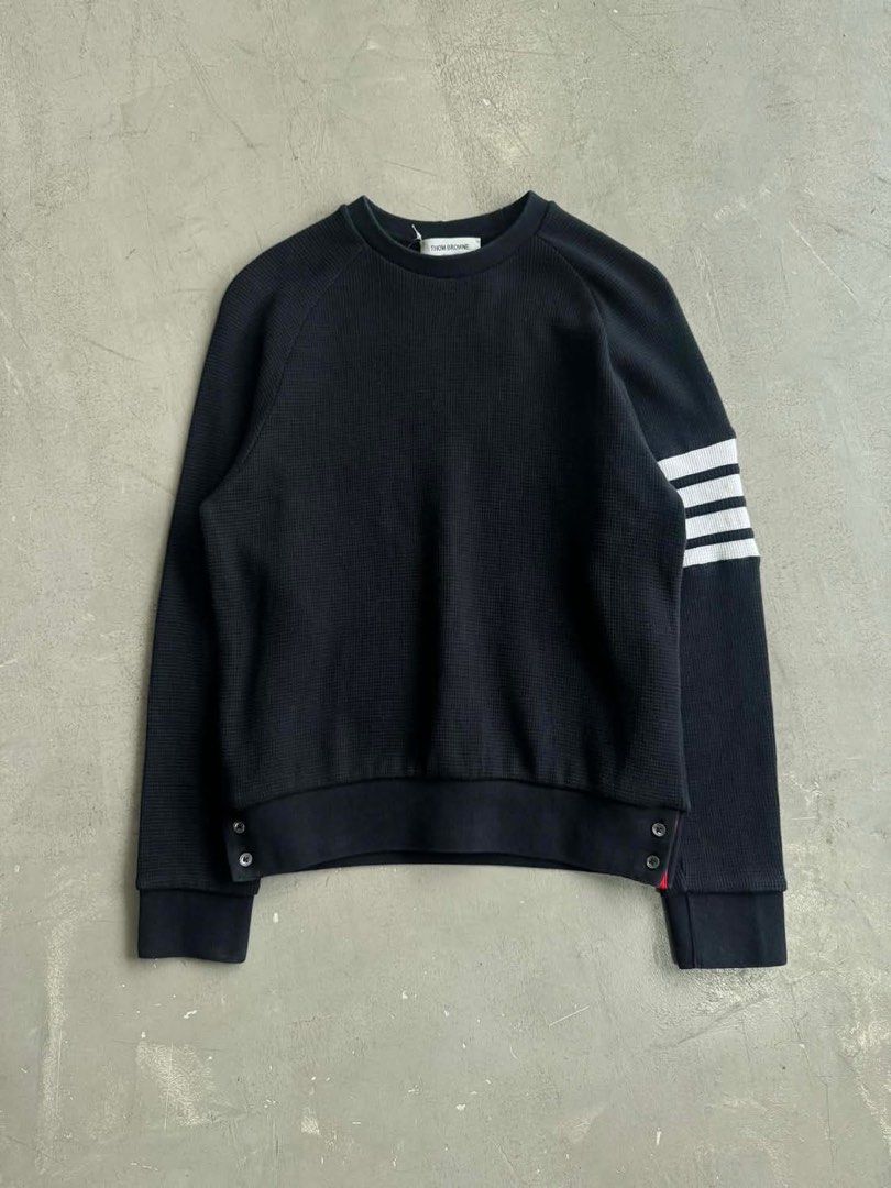 Thom Browne Black Sweatshirt with Stripes (Category: Luxury Apparel) located in Manila. Submitted by archivedrip (Listing ID 1428096550, Image 1). Description: Authentic Thom Browne sweatshirt in black. Features the brand's signature white stripes on the left sleeve. Made in Italy. The fabric composition includes cotton and elastane. Details include buttoned cuffs and a crew neck. The size is indicated as 1..