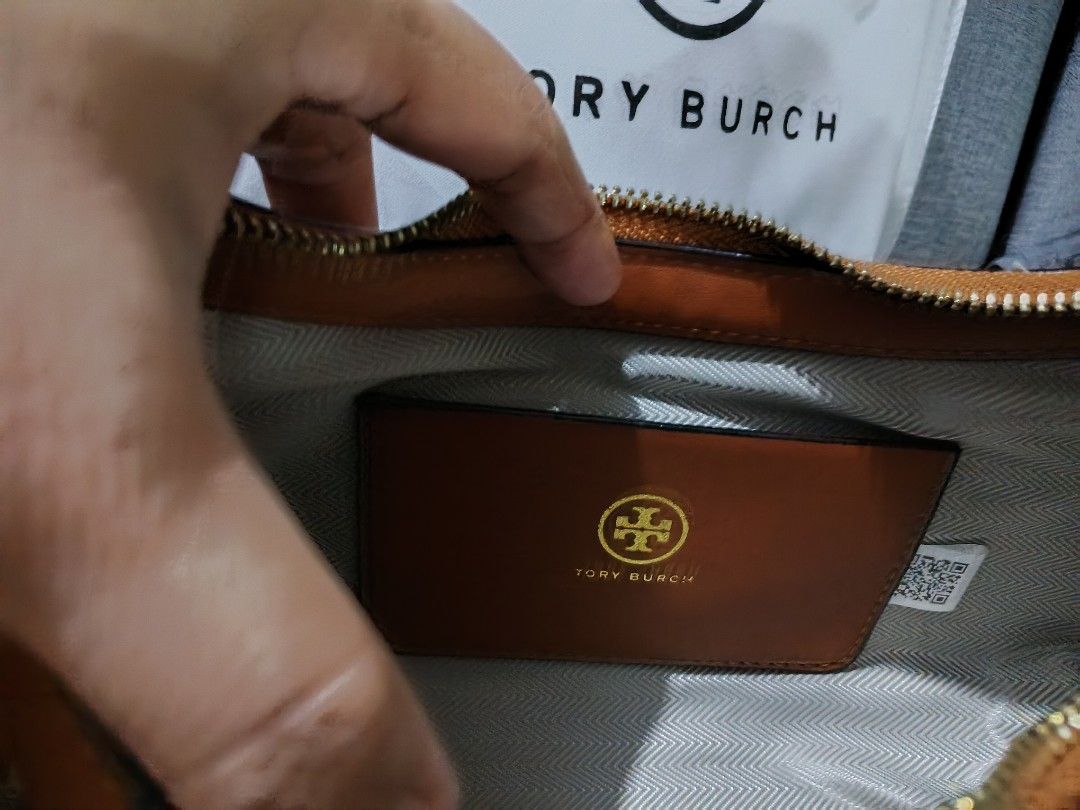 Tory Burch Shoulder Bag (Category: Luxury Bags & Wallets) located in San Fernando. Submitted by goodbuys47 (Listing ID 1428082620, Image 3). Description: Authentic Tory Burch shoulder bag. Features a brown and beige pattern with a gold zipper and hardware. Includes a dust bag and original box. The interior has a small pocket with the Tory Burch logo. Comes with a detachable strap..