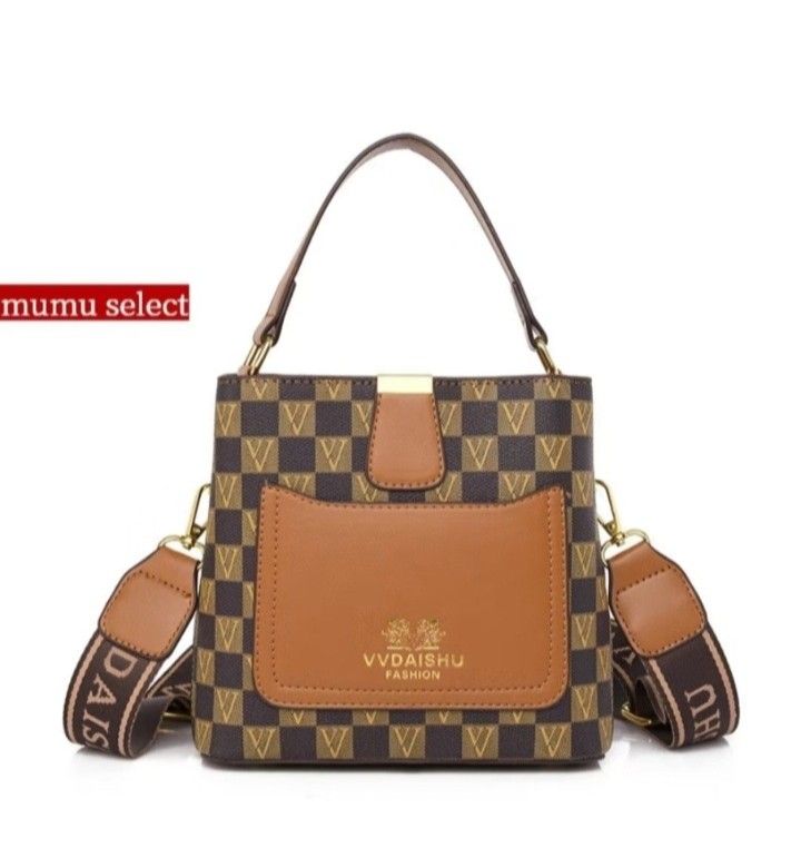 VVDAISHU Checkered Bucket Bag (Category: Luxury Bags & Wallets) located in Talavera. Submitted by wearjayz.1994 (Listing ID 1428014447, Image 1). Description: Stylish bucket bag featuring a checkered pattern and a brown accent pocket. It has a top handle and a detachable shoulder strap with the brand name. The interior has multiple compartments for organizing essentials. The bag is suitable for everyday use and offers a fashionable look..