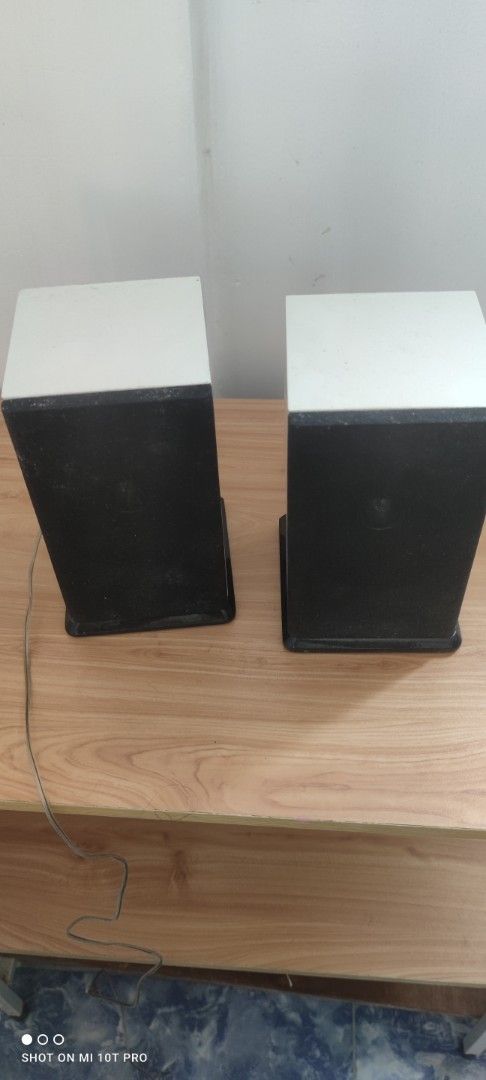 White and Black Speakers (Category: Soundbars, Speakers & Amplifiers) located in Cavite. Submitted by Combiishop (Listing ID 1427952598, Image 2). Description: Pair of speakers with a white top and black front. Includes attached wires. The speakers are rectangular in shape. They are designed to sit upright. The speakers are suitable for use with a variety of audio devices..