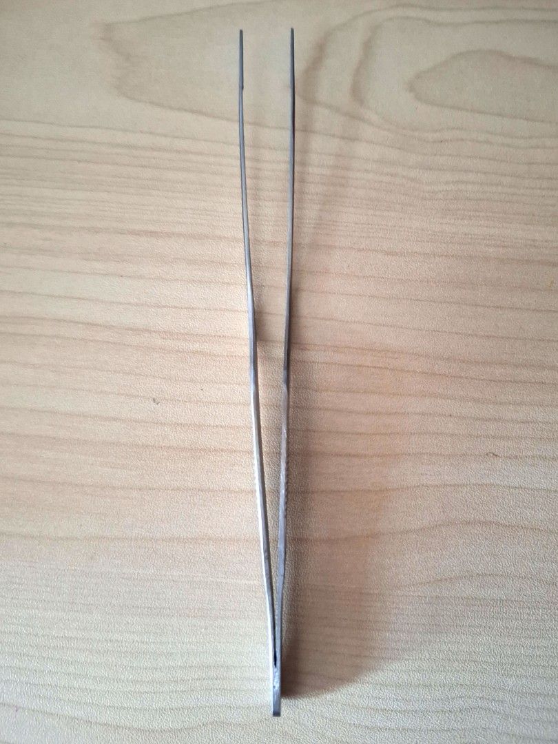 16.5cm curved Tweezer (Category: Other Kitchenware & Tableware) located in Quezon City. Submitted by an.marie (Listing ID 1428158946, Image 2). Description: These tweezers are made of stainless steel. They have a ridged grip for better handling. The tips are fine and precise, suitable for detailed work. The tweezers are straight and have a pointed tip..