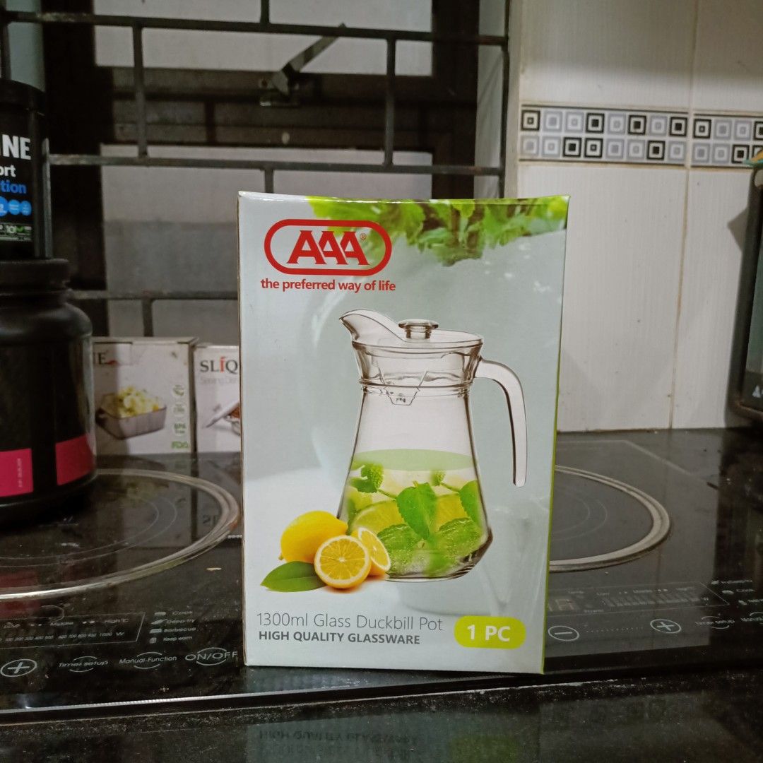 AAA 1300ml Glass Duckbill Pot (Category: Pitchers & Dispensers) located in Makati City. Submitted by crstnemrise (Listing ID 1428183651, Image 1). Description: 1300ml glass duckbill pot from AAA. It is made of high-quality glassware. The pitcher comes with a lid and a handle for easy pouring. It is perfect for serving cold beverages like juice, iced tea, or infused water. The box indicates it is a single piece..