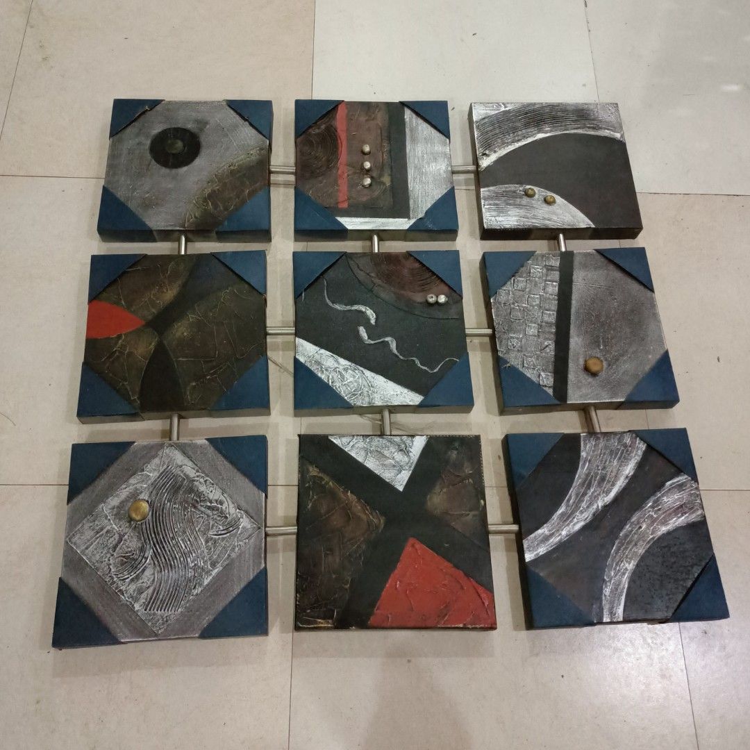 Abstract Square Wall Art (Category: Wall Decor) located in Makati City. Submitted by crstnemrise (Listing ID 1428119406, Image 2). Description: Unique abstract wall art featuring nine square panels. Each panel has a different design with a mix of colors, textures, and metallic accents. The panels are connected by metal rods, creating a cohesive and modern look. Perfect for adding a touch of artistic flair to any room. •Collapsible Painting •Orig.