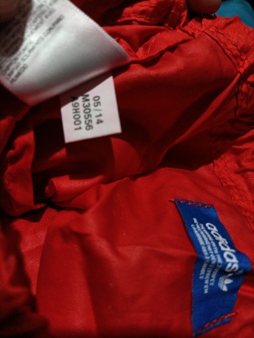 Adidas Originals Drawstring Bag (Category: Backpacks) located in Bocaue. Submitted by michellesell_2 (Listing ID 1428228822, Image 3). Description: Red drawstring bag featuring the Adidas Originals logo. The bag has a large white circular design with the word "ORIGINALS" and a large "A" in the center. The Adidas trefoil logo is visible below the "A"..