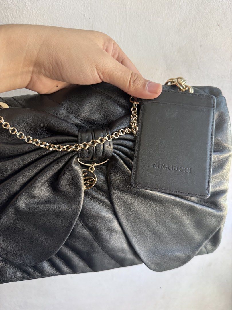 Authentic Nina Ricci Black Bow Shoulder Bag (Category: Luxury Bags & Wallets) located in Manila. Submitted by thriftyhaven2023 (Listing ID 1428105853, Image 3). Description: - Authentic Nina Ricci shoulder bag - Features a unique bow design - Classic black color - Gold chain strap - Perfect for everyday use or special occasions 9/10 condition Pristine condition .