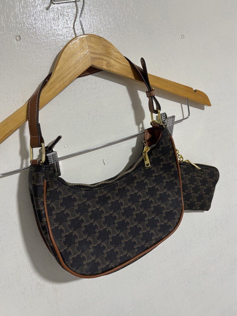 Celine Triomphe Shoulder Bag with Coin Purse (Category: Luxury Bags & Wallets) located in Naga. Submitted by unknwnstreetwear (Listing ID 1428193983, Image 2). Description: No issue Shoulder bag Width- 10 inches Length-7 inches Coin purse Width-5 inches Length-4 inches Celine Triomphe shoulder bag features the iconic Triomphe print. It comes with a matching coin purse. The bag has a brown leather strap and trim, with gold-tone hardware. The zippe
