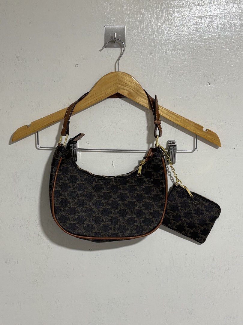 Celine Triomphe Shoulder Bag with Coin Purse (Category: Luxury Bags & Wallets) located in Naga. Submitted by unknwnstreetwear (Listing ID 1428193983, Image 1). Description: No issue Shoulder bag Width- 10 inches Length-7 inches Coin purse Width-5 inches Length-4 inches Celine Triomphe shoulder bag features the iconic Triomphe print. It comes with a matching coin purse. The bag has a brown leather strap and trim, with gold-tone hardware. The zippe