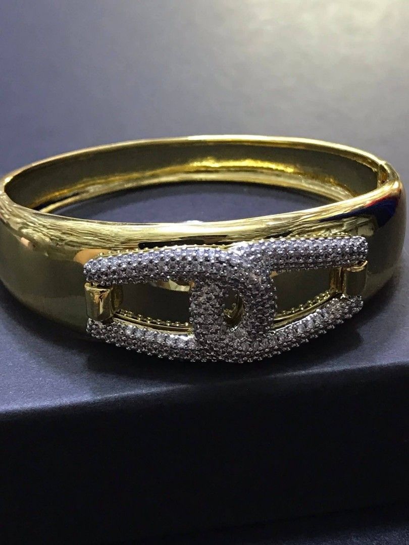 Chanel Gold Bracelet with Crystals (Category: Luxury Accessories) located in Manila. Submitted by celstainlessjewelry (Listing ID 1428186024, Image 2). Description: Elegant gold bracelet featuring a prominent Chanel logo embellished with sparkling crystals. The bracelet has a polished, reflective surface. The bracelet is presented in a black box, suggesting it is a luxury item..